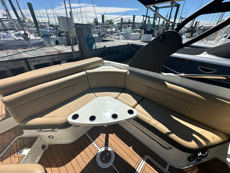 Slide: The Image of 2019 Sea Ray SLX 280 boat with tan seating and a dockside view. - 11