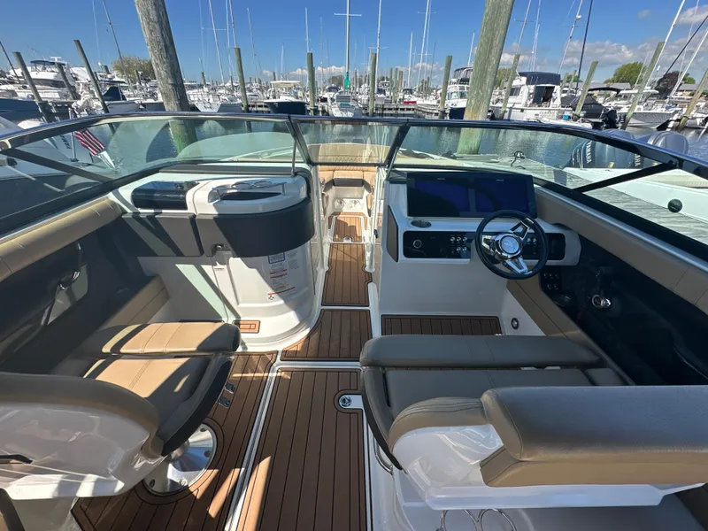 Slide: The Image of 2019 Sea Ray SLX 280 boat interior with modern dashboard and seating at marina. - 14