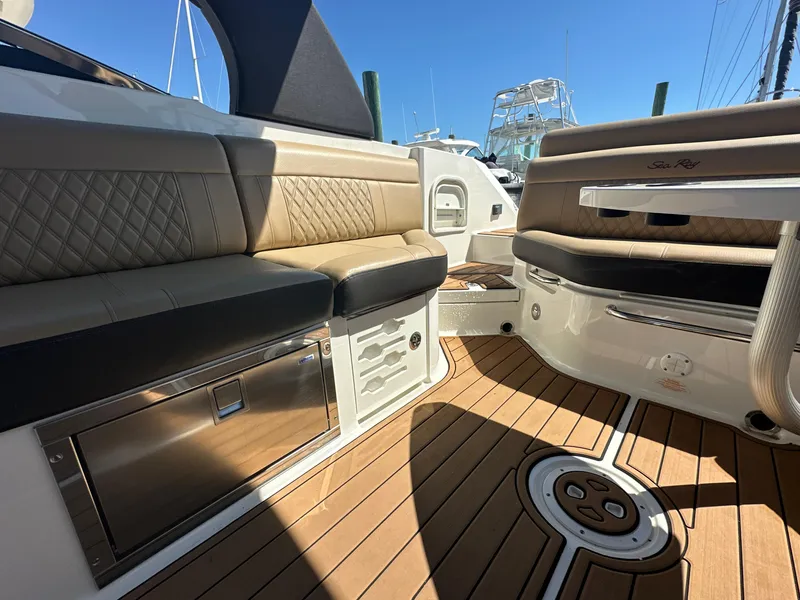 Slide: The Image of 2019 Sea Ray SLX 280 interior with luxurious seating and teak flooring. - 18