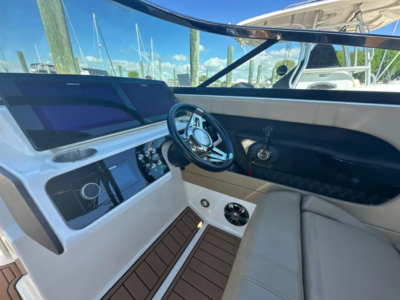 Slide: The Image of 2019 Sea Ray SLX 280 boat interior with steering wheel and control panel. - 20