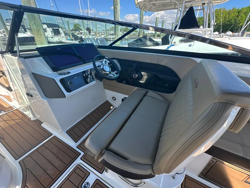 Slide: The Image of 2019 Sea Ray SLX 280 boat cockpit with modern steering and seating. - 22