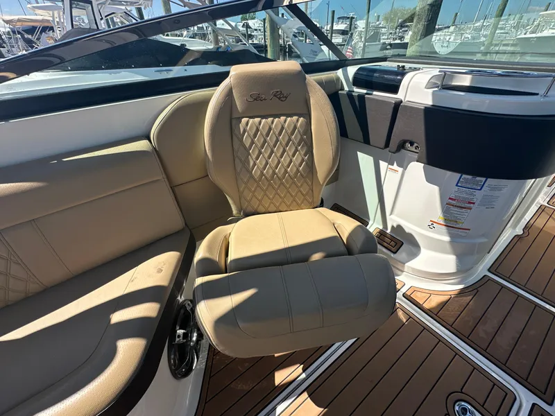 Slide: The Image of 2019 Sea Ray SLX 280 boat interior with tan leather seating and wood flooring. - 26