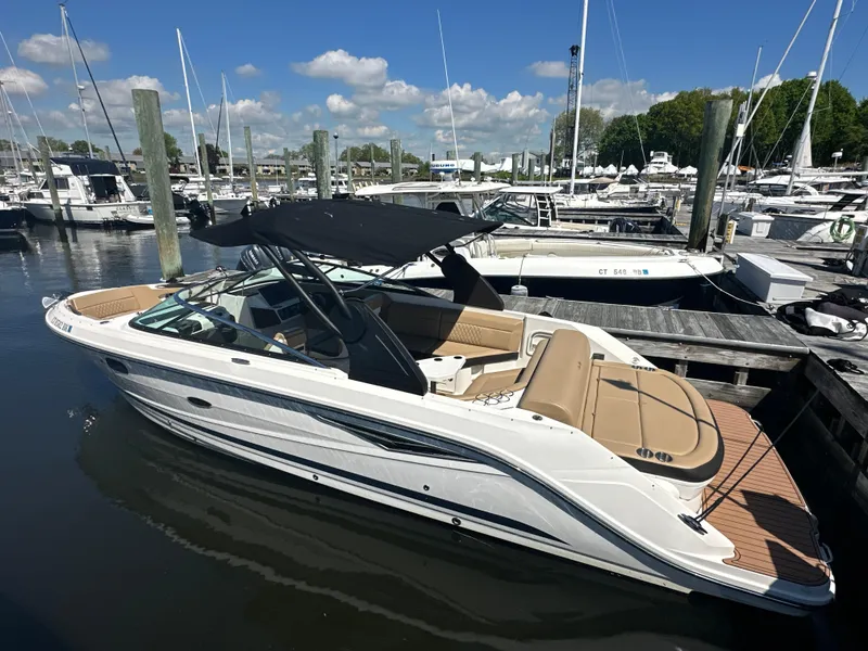 Slide: The Image of 2019 Sea Ray SLX 280 boat docked at marina under clear blue sky. - 3