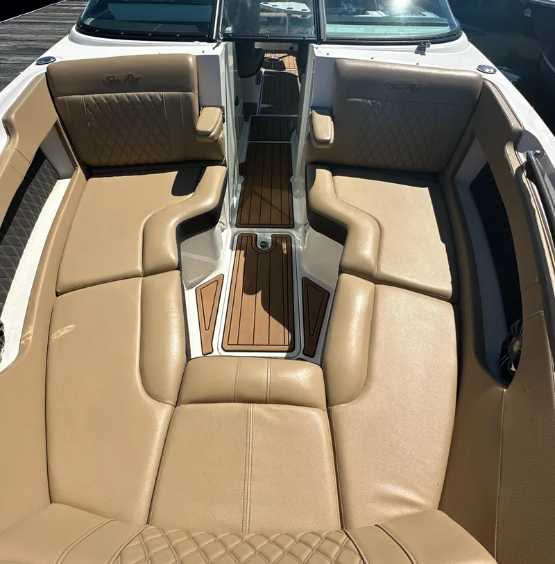 Slide: The Image of 2019 Sea Ray SLX 280 boat interior with tan leather seating and wood accents. - 32