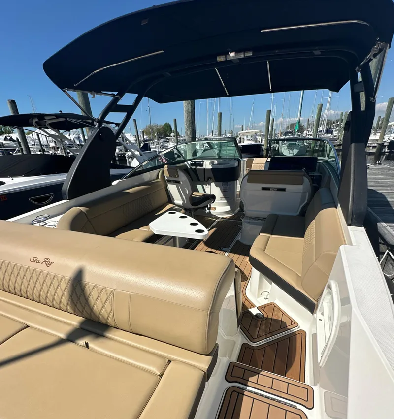 Slide: The Image of 2019 Sea Ray SLX 280 boat with tan seating and sleek design at a marina. - 38