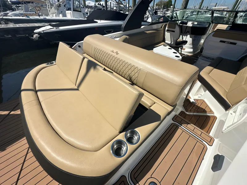 Slide: The Image of 2019 Sea Ray SLX 280 boat interior with tan leather seating and cup holders. - 41