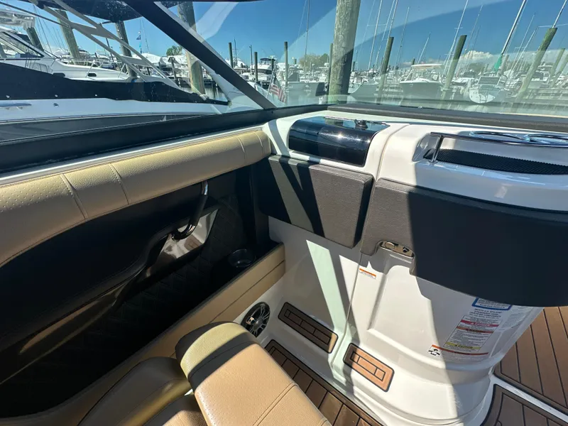 Slide: The Image of Interior view of 2019 Sea Ray SLX 280 boat with tan seating and dashboard. - 42