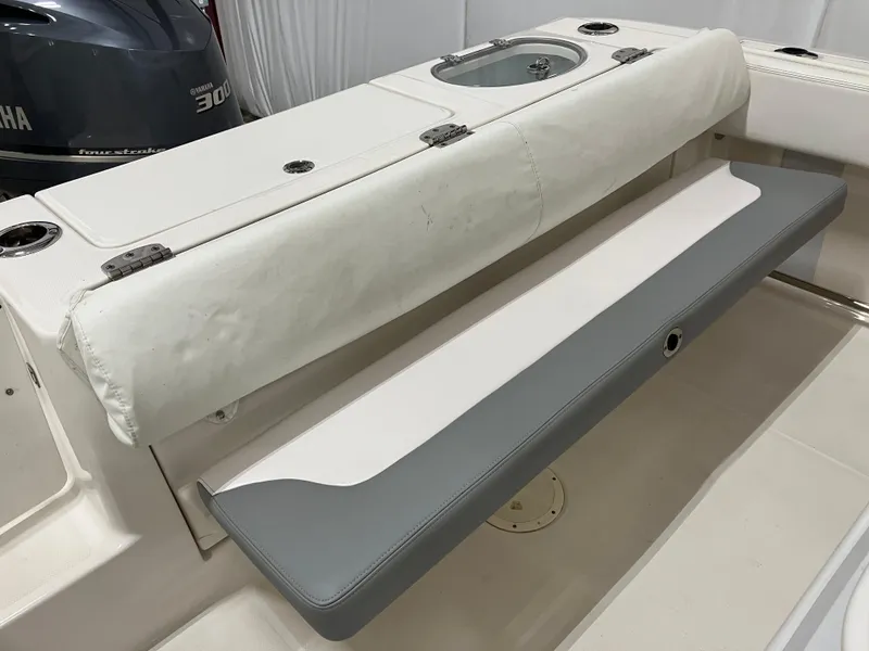 Slide: The Image of 2021 Robalo R242 Center Console boat seating and storage area. - 13