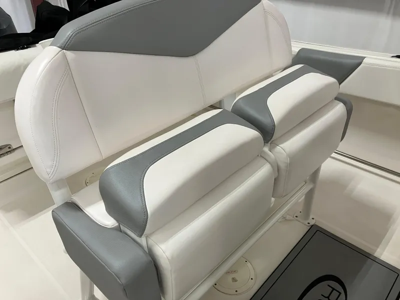 Slide: The Image of 2021 Robalo R242 Center Console boat seating with gray and white upholstery. - 14