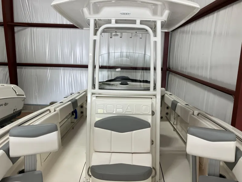 Slide: The Image of 2021 Robalo R242 Center Console boat interior with seating and console in storage. - 16