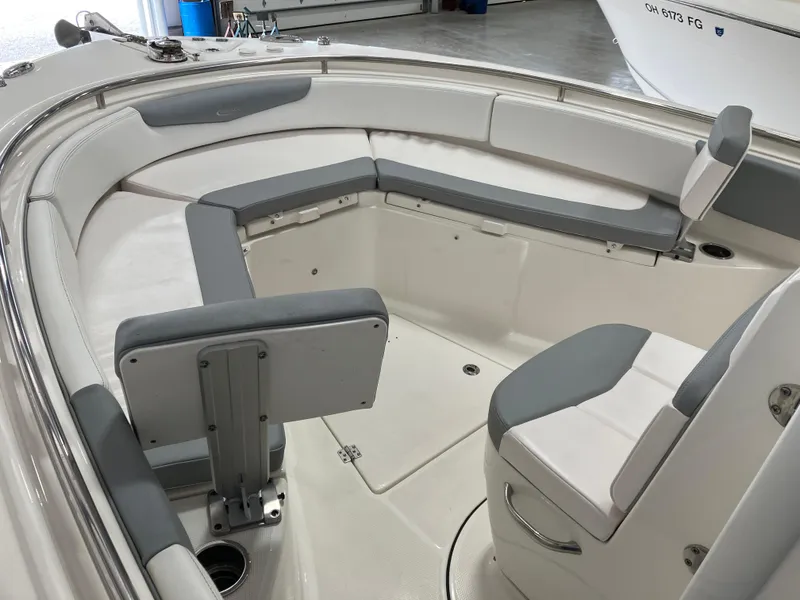 Slide: The Image of 2021 Robalo R242 Center Console boat interior with gray and white seating. - 18