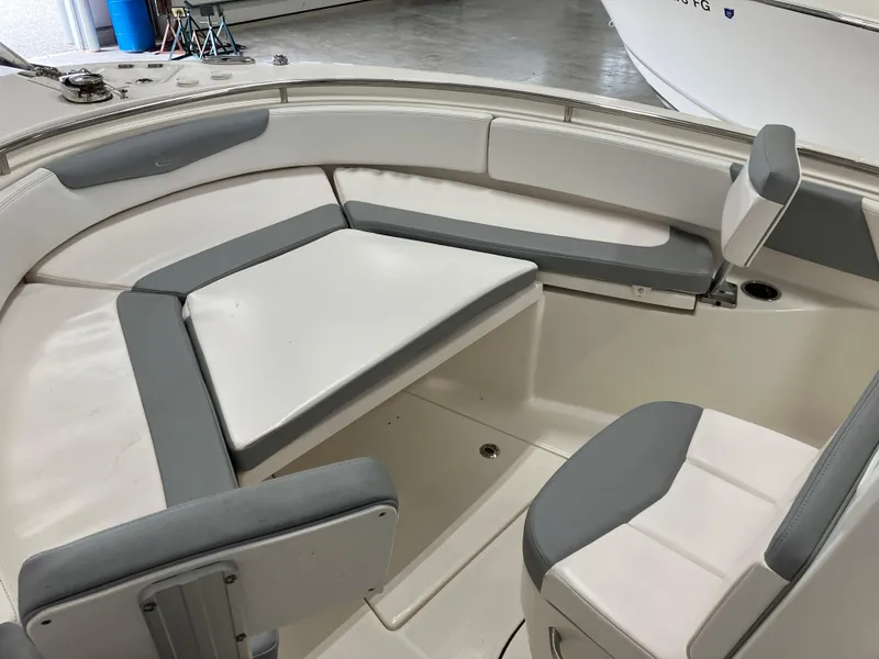 Slide: The Image of 2021 Robalo R242 Center Console boat interior with cushioned seating. - 19