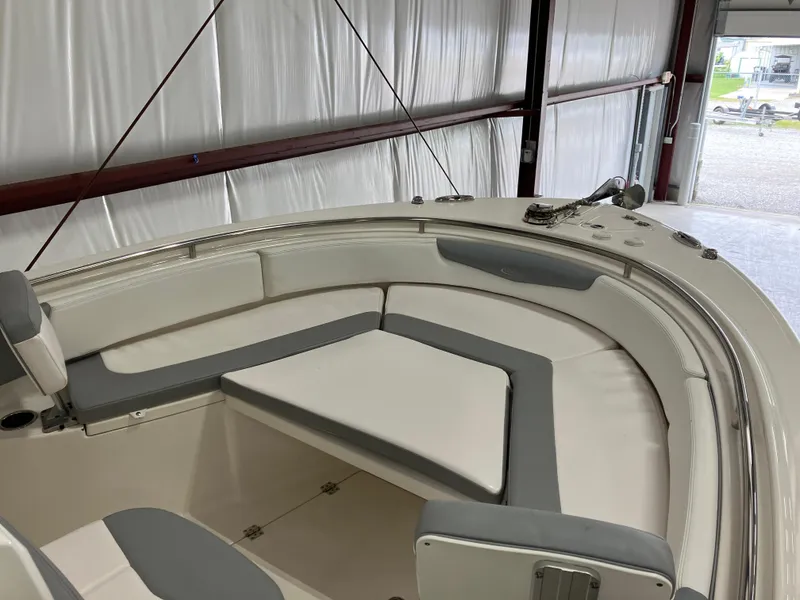 Slide: The Image of 2021 Robalo R242 Center Console boat interior with cushioned seating in a storage area. - 20