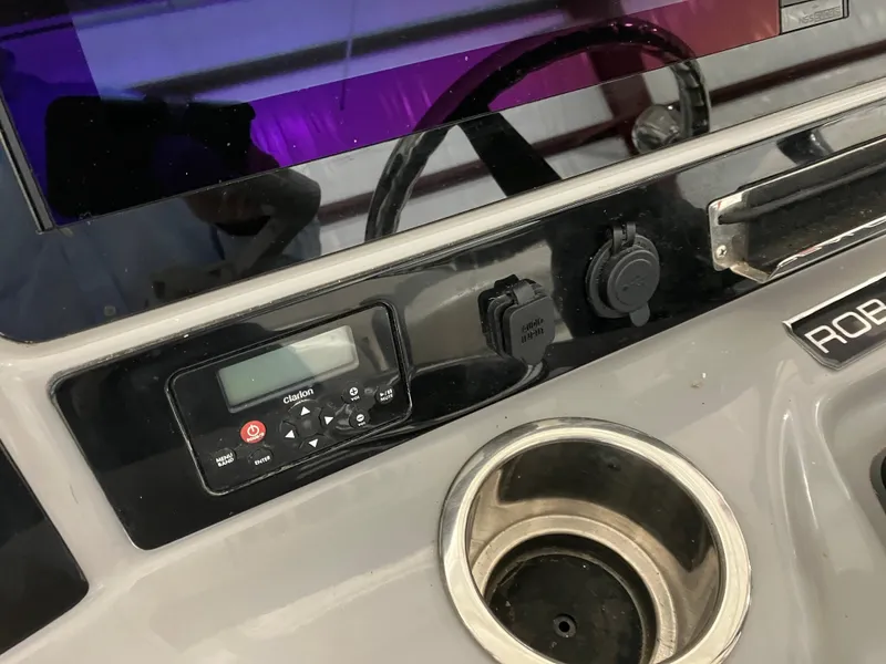 Slide: The Image of 2021 Robalo R242 Center Console dashboard with controls and cup holder. - 30
