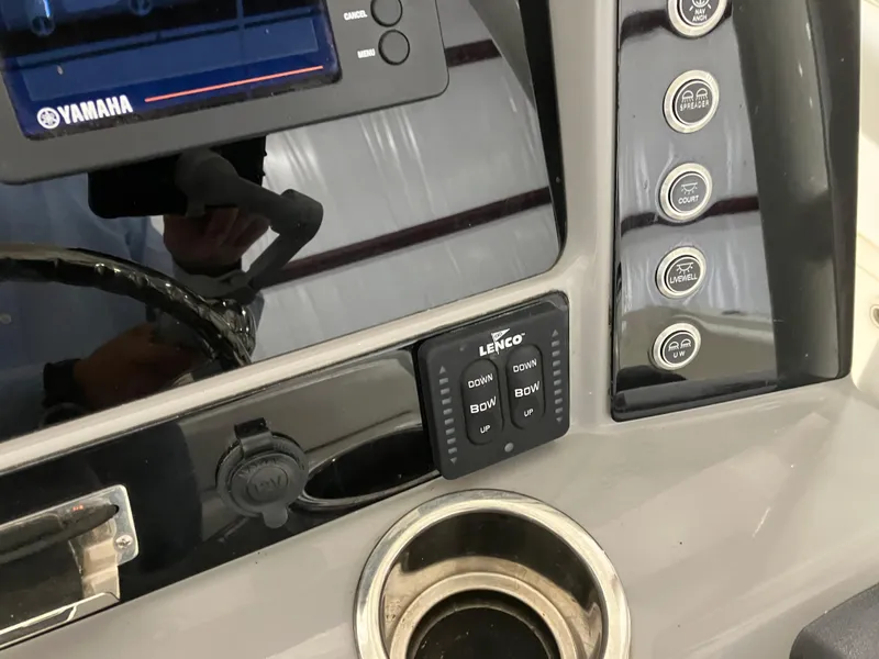 Slide: The Image of 2021 Robalo R242 Center Console dashboard with Yamaha controls and Lenco trim tab switches. - 31