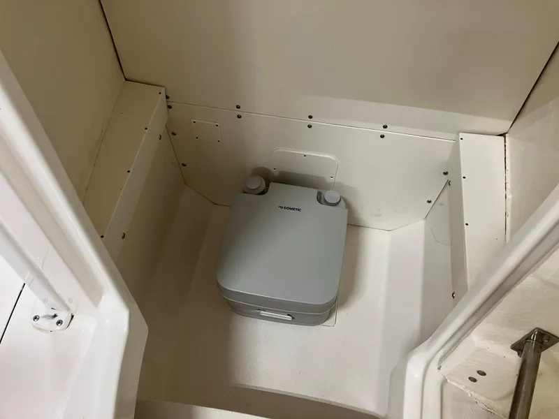 Slide: The Image of Portable toilet in 2021 Robalo R242 Center Console boat interior. - 39