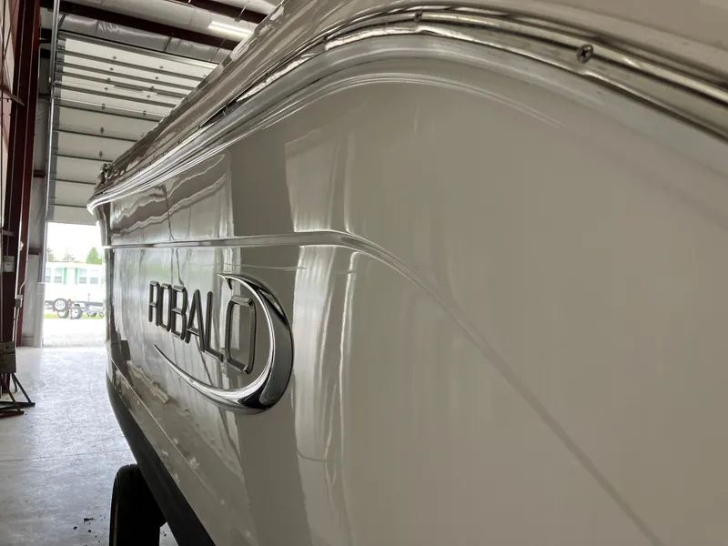 Slide: The Image of 2021 Robalo R242 Center Console boat in a garage, side view. - 4
