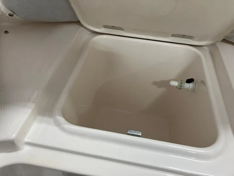 Slide: The Image of 2021 Robalo R242 Center Console storage compartment with open lid. - 41