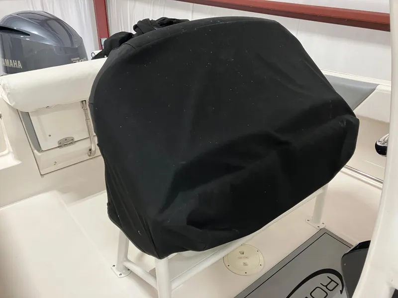Slide: The Image of 2021 Robalo R242 Center Console boat interior with covered console and Yamaha engine. - 44