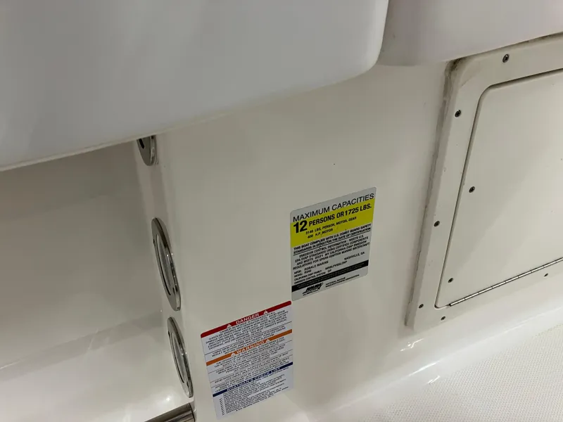 Slide: The Image of 2021 Robalo R242 Center Console boat capacity label, maximum 12 persons or 1725 lbs. - 47