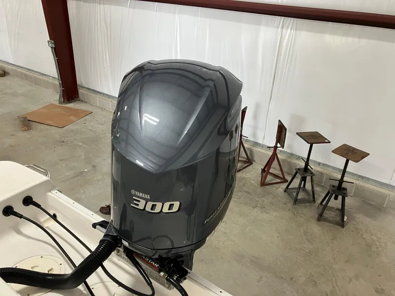 Slide: The Image of Yamaha 300 outboard motor on 2021 Robalo R242 Center Console boat in a garage. - 5