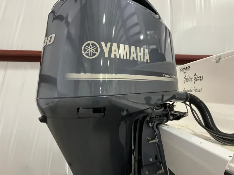 Slide: The Image of Yamaha outboard motor on 2021 Robalo R242 Center Console boat in a storage facility. - 6