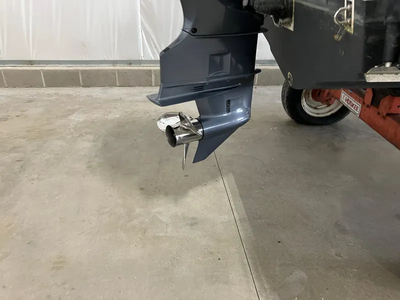 Slide: The Image of 2021 Robalo R242 Center Console boat engine propeller in a garage. - 7