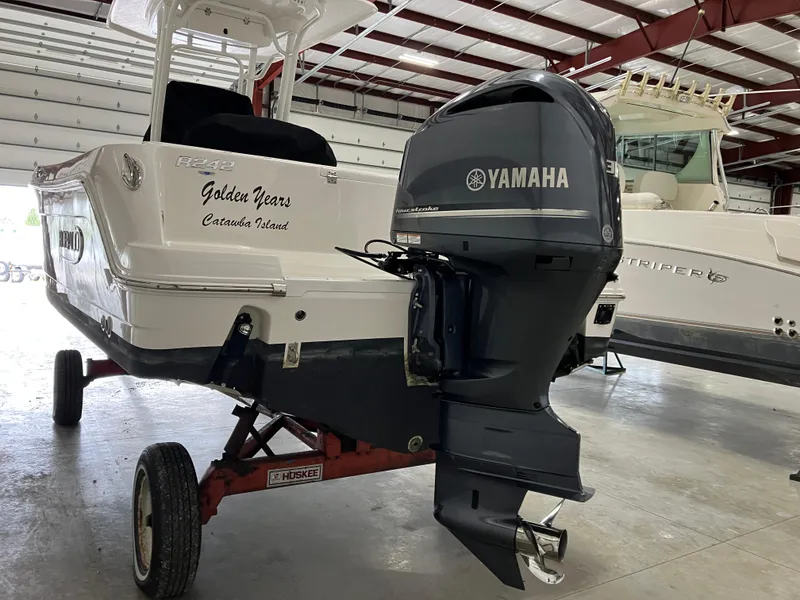 Slide: The Image of 2021 Robalo R242 Center Console boat with Yamaha outboard motor in a storage facility. - 9