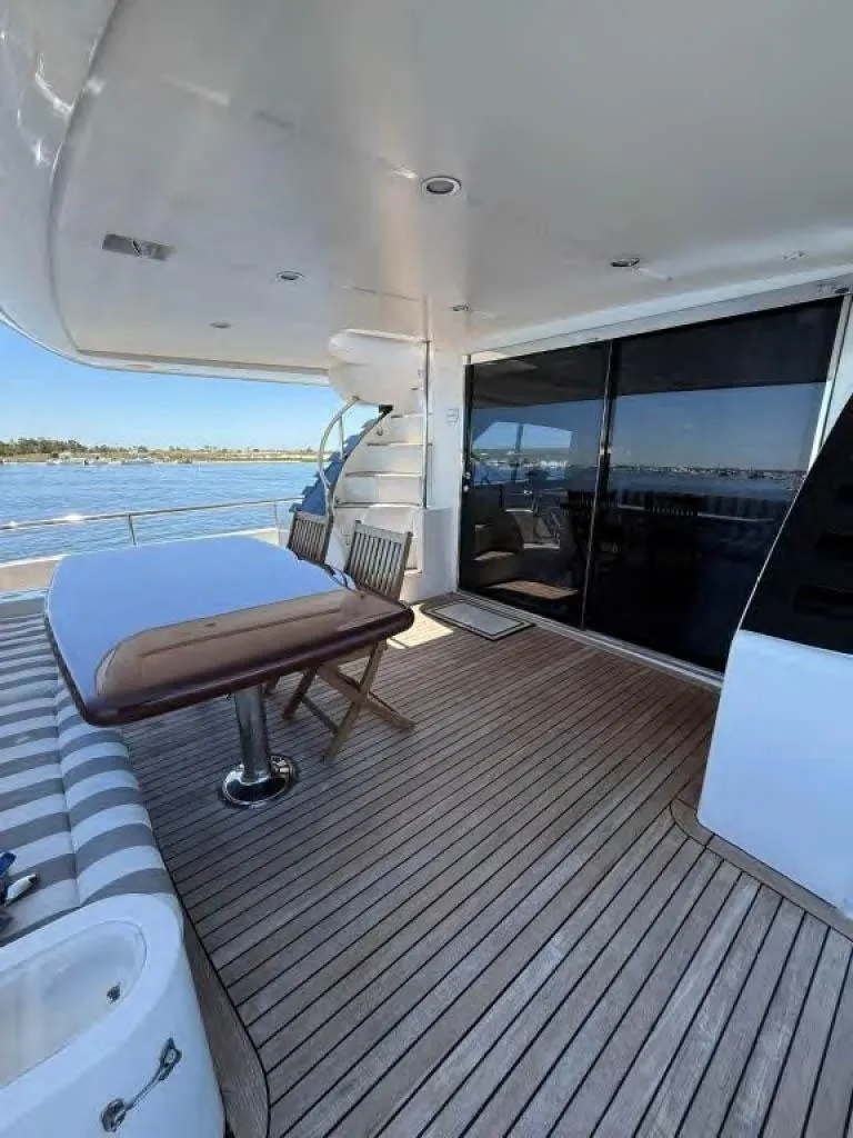 Slide: The Image of Luxury yacht deck with seating, Horizon E 65, 2000 model, overlooking serene waters. - 10