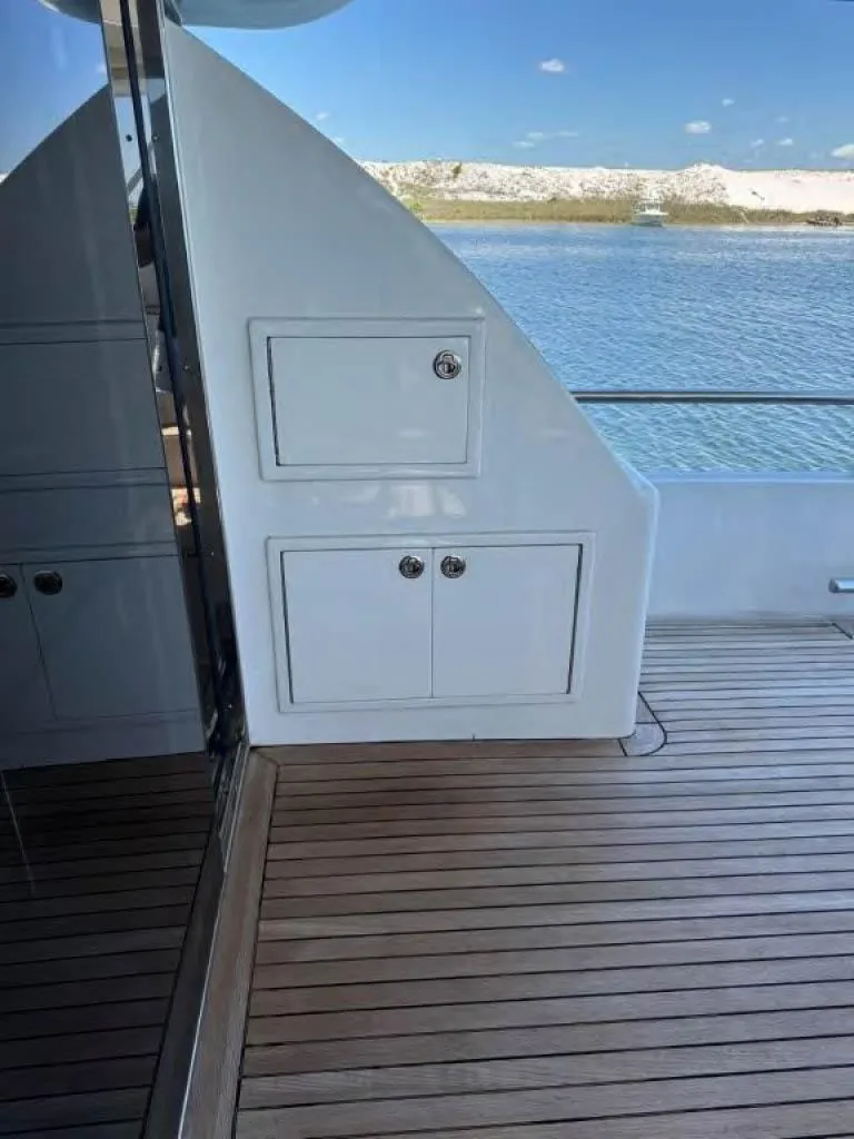 Slide: The Image of Deck of 2000 Horizon E 65 yacht with wooden flooring and storage compartments. - 11