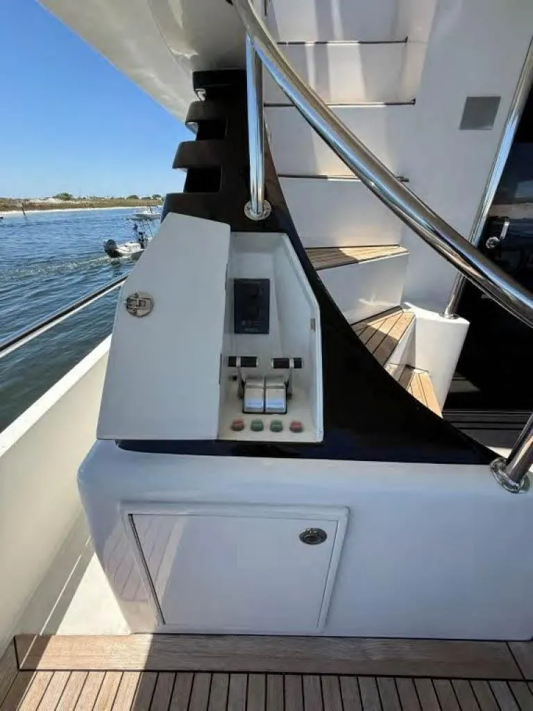 Slide: The Image of Control panel on 2000 Horizon E 65 yacht with stairs and water view. - 12