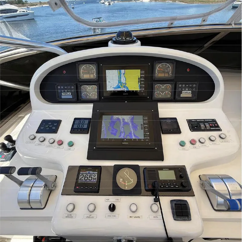 Slide: The Image of Control panel of a 2000 Horizon E 65 yacht with navigation screens and instruments. - 15