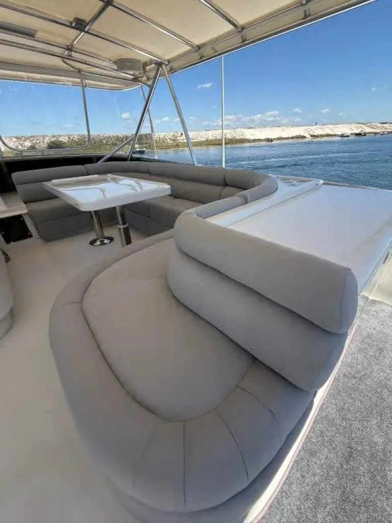 Slide: The Image of Luxurious Horizon E 65 yacht interior with plush seating, dining area, and ocean view. - 16