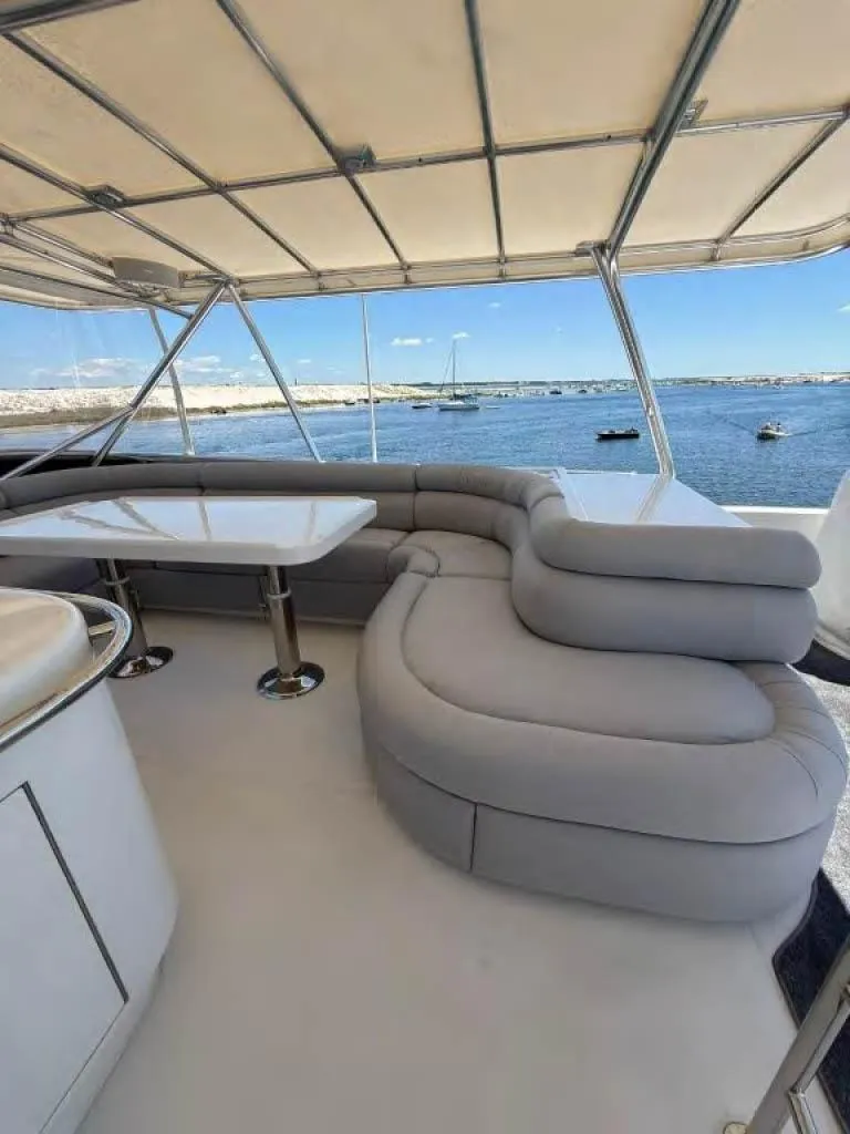 Slide: The Image of Luxurious Horizon E 65 yacht interior with plush seating and ocean view, 2000 model. - 17