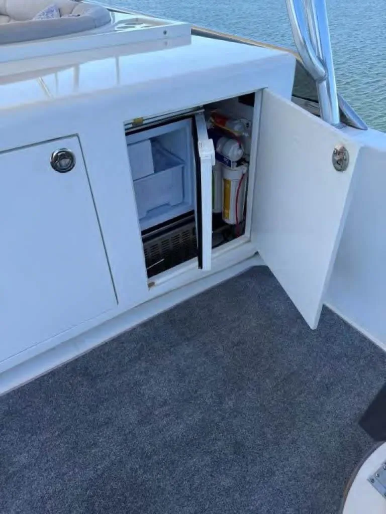 Slide: The Image of Open cabinet with mini fridge on Horizon E 65 yacht, 2000 model. - 24