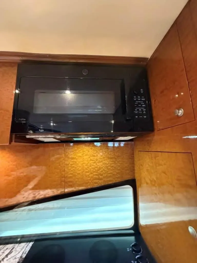 Slide: The Image of Microwave in Horizon E 65 yacht kitchen, 2000 model, with wooden cabinetry. - 29