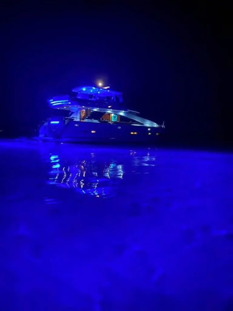 Slide: The Image of Horizon E 65 yacht illuminated with blue lights on water at night, 2000 model. - 3
