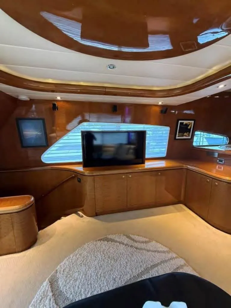 Slide: The Image of Luxurious interior of 2000 Horizon E 65 yacht with modern wood paneling and entertainment system. - 39