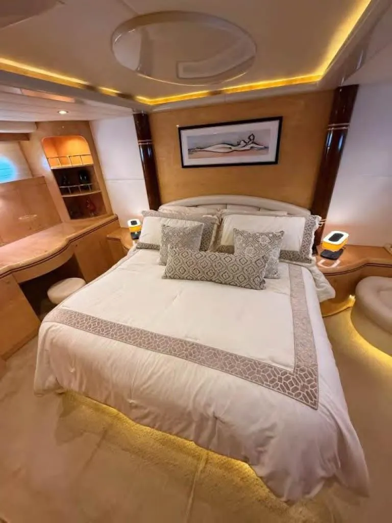 Slide: The Image of Luxurious bedroom interior on 2000 Horizon E 65 yacht, featuring elegant bedding and ambient lighting. - 44