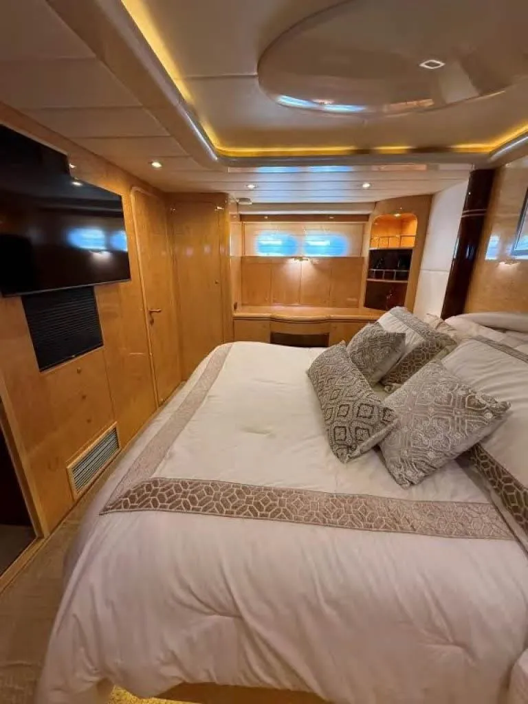 Slide: The Image of Luxurious bedroom interior of 2000 Horizon E 65 yacht with elegant bedding and ambient lighting. - 45