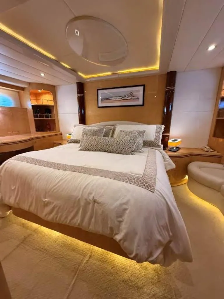 Slide: The Image of Luxurious bedroom interior on 2000 Horizon E 65 yacht, featuring elegant lighting and plush bedding. - 46