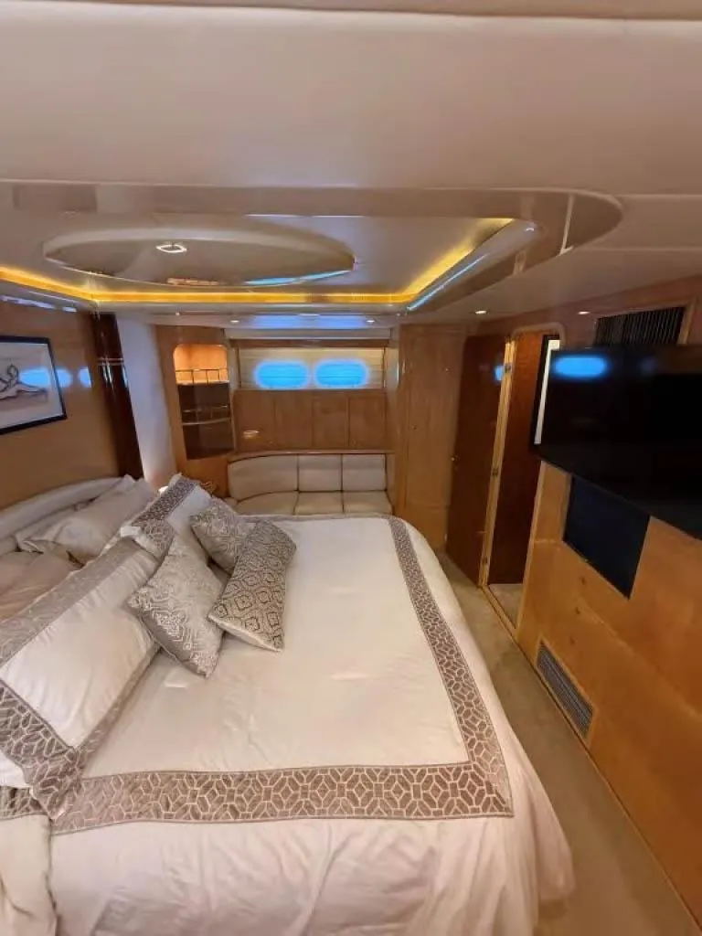 Slide: The Image of Luxurious bedroom interior of 2000 Horizon E 65 yacht with elegant bedding and modern amenities. - 47