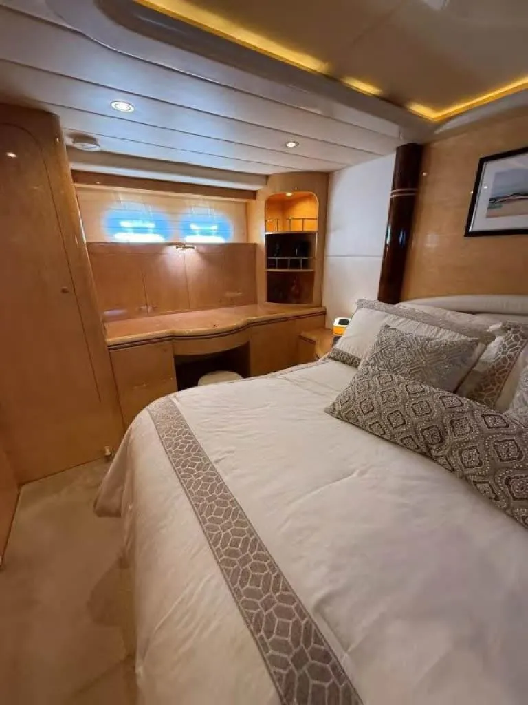 Slide: The Image of Luxurious bedroom in 2000 Horizon E 65 yacht with elegant bedding and wood finishes. - 49