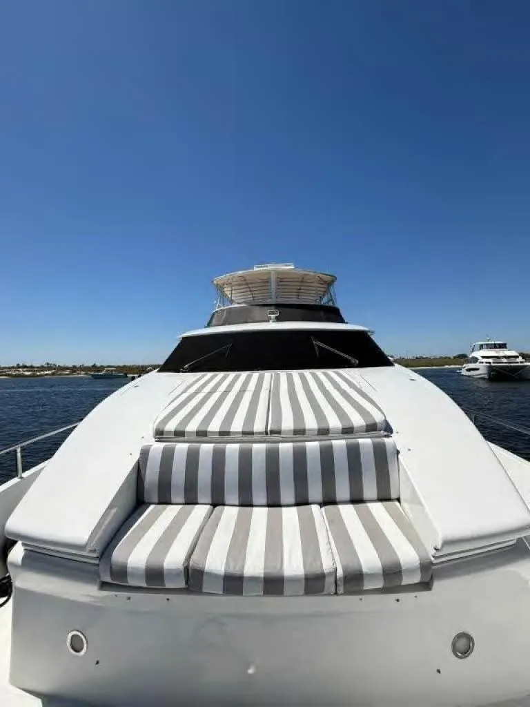 Slide: The Image of Luxury Horizon E 65 yacht, 2000 model, with striped sunbathing deck on open water. - 7