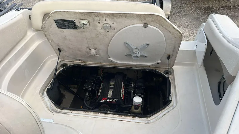 Slide: The Image of 2000 Regal Commodore 2460 boat engine compartment with open hatch, revealing 5.0L engine. - 12