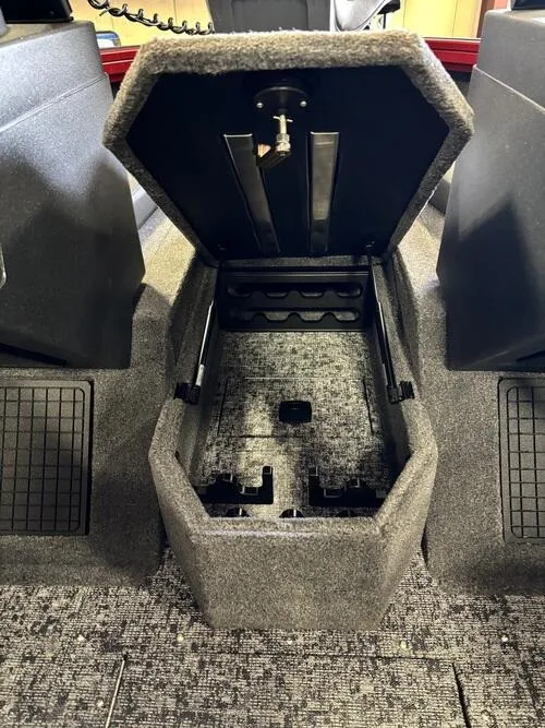 Slide: The Image of Storage compartment in 2025 Tracker Targa V-19 Combo boat with yellow lid and gray interior. - 10