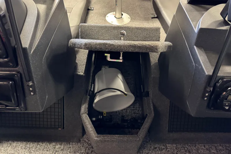 Slide: The Image of 2025 Tracker Targa V-19 Combo boat interior storage compartment with bucket. - 13