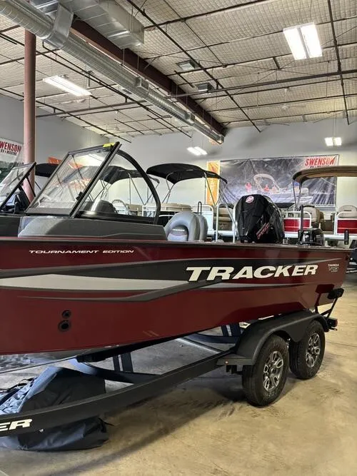 Slide: The Image of 2025 Tracker Targa V-19 Combo boat with powerful outboard motor in a showroom. - 2