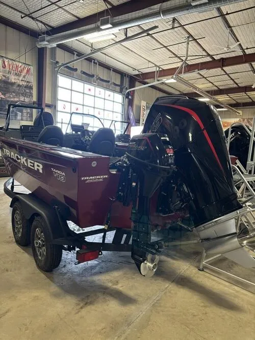 Slide: The Image of 2025 Tracker Targa V-19 Combo boat with dual Mercury outboard motors in a showroom. - 3