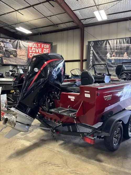 Slide: The Image of 2025 Tracker Targa V-19 Combo boat interior with four cushioned seats and red accents. - 4